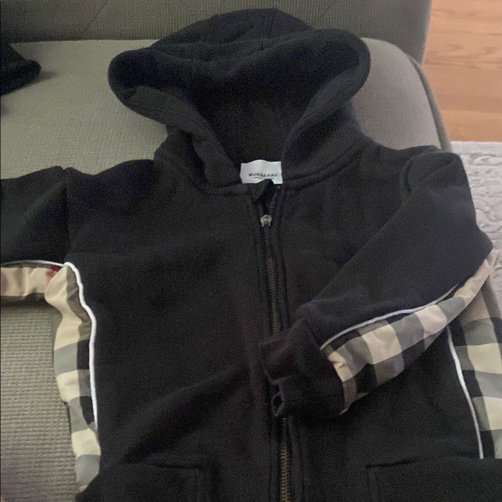 Burberry Black Hoodie. The zippers top handler is broken. It zips without it.